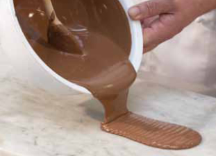 pouring chocolate onto a marble slab