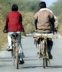 two people riding bicycles