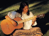 lady playing acoustic guitar