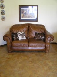 brown sofa on painted concrete floor
