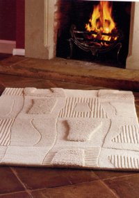 white sculptured rug in front of hearth