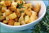 a bowl of cubed potatoes and rosemary