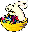 rabbit sitting in a basket with some flowers